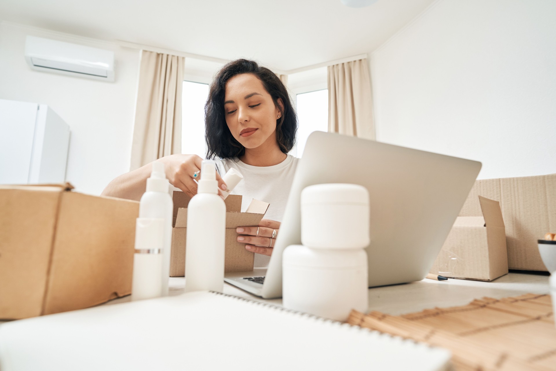 Internet shop employee packing items for shipping